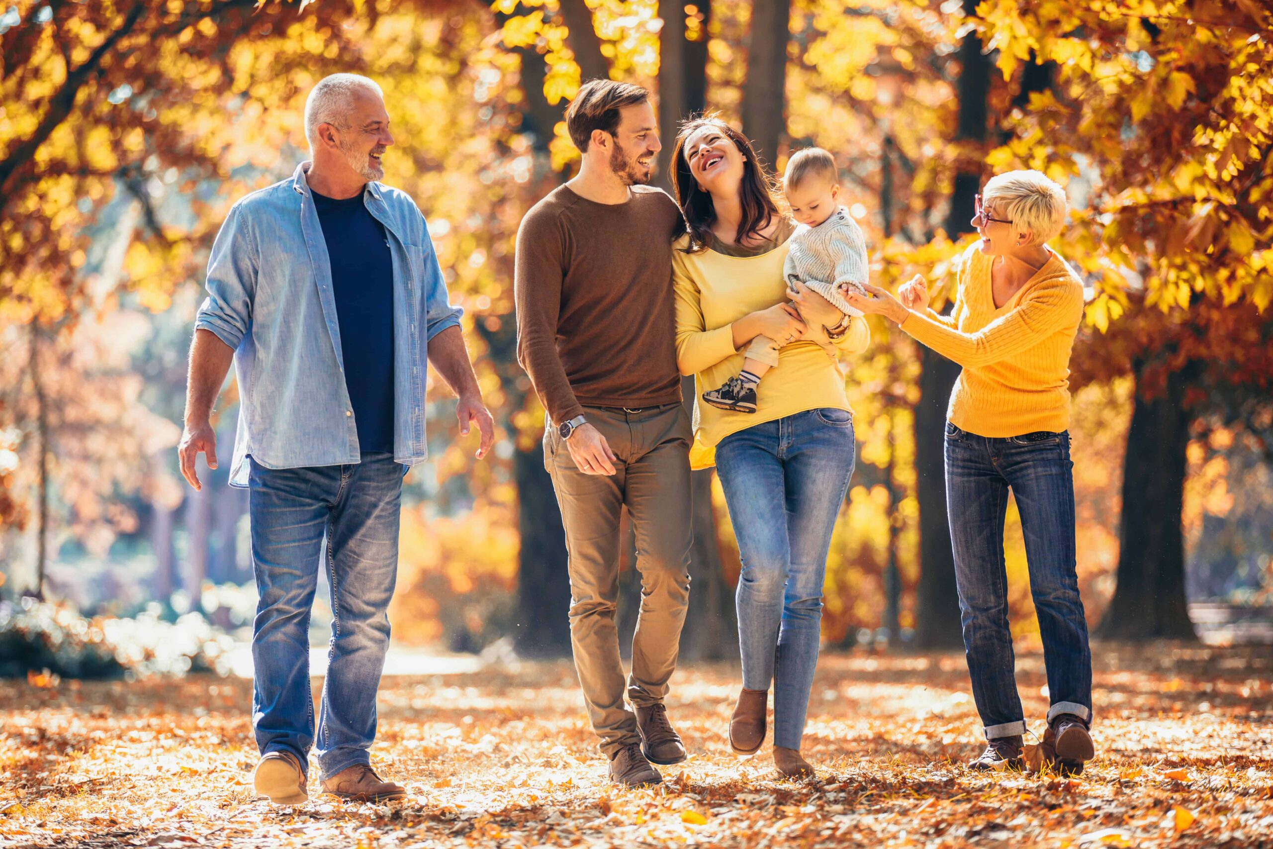 3 generations - family taking a walk in nature - picture of wellness and health.