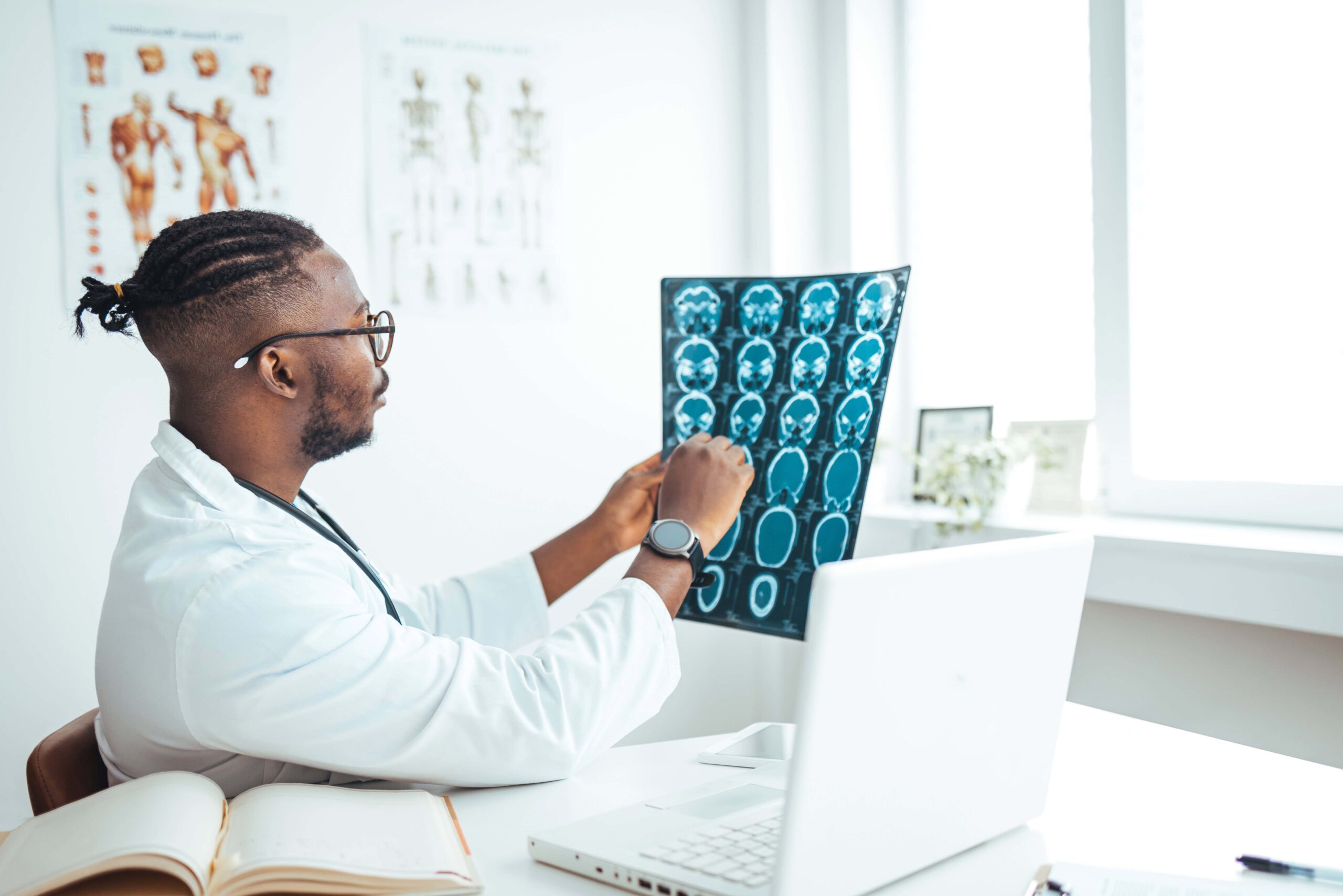 Neurologist looking at brain scans which all show different neurological states.